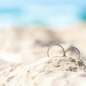 Wedding rings for couple lover on the sandy beach. Engagement rings in honeymoon vacation in tropics.  Valentine Concept.  soft and select focus